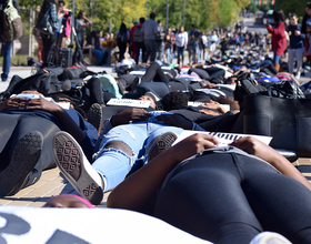 Syracuse University community members stage die-in on University Place promenade