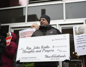 Activists deliver Rep. Katko a check for ‘Thoughts and Prayers’ at gun control protest