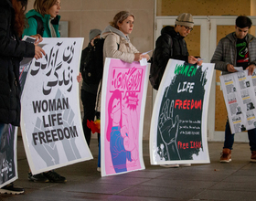 Students rally outside HBC in rain and wind in support of ongoing protests in Iran