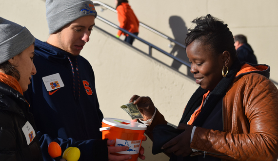 Braving the cold, these students raised money for hurricane relief efforts outside the Carrier Dome on Saturday