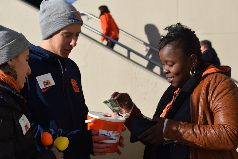 Braving the cold, these students raised money for hurricane relief efforts outside the Carrier Dome on Saturday