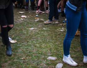 Syracuse University students party in the rain outside Walnut Park on Mayfest