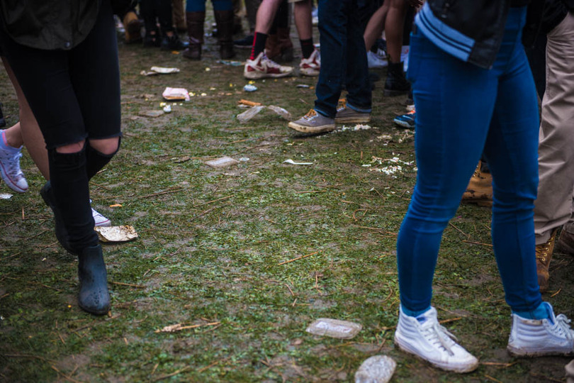 Syracuse University students party in the rain outside Walnut Park on Mayfest