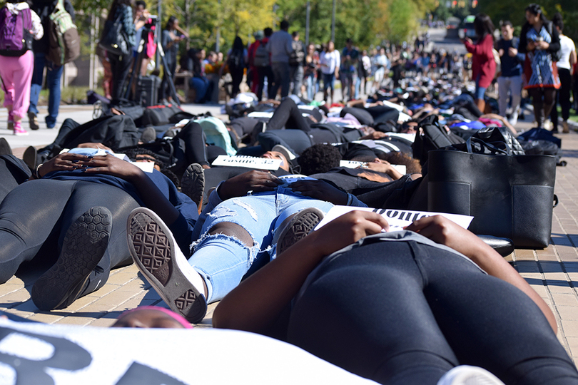 Syracuse University community members stage die-in on University Place promenade