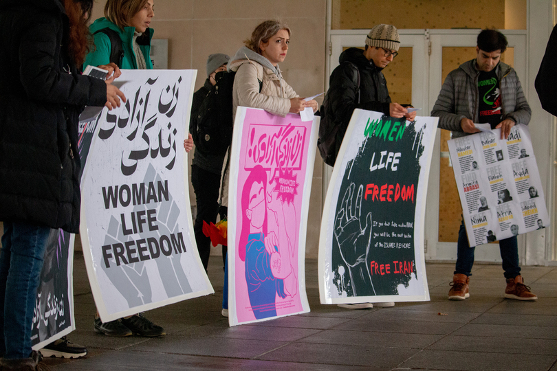 Students rally outside HBC in rain and wind in support of ongoing protests in Iran